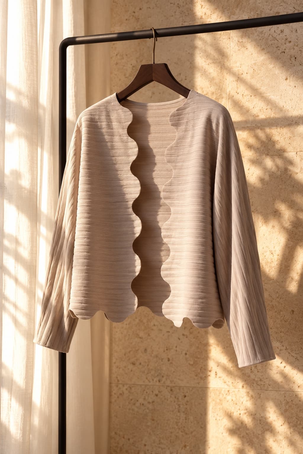 The scalloped Tsuki cardigan in warm window light